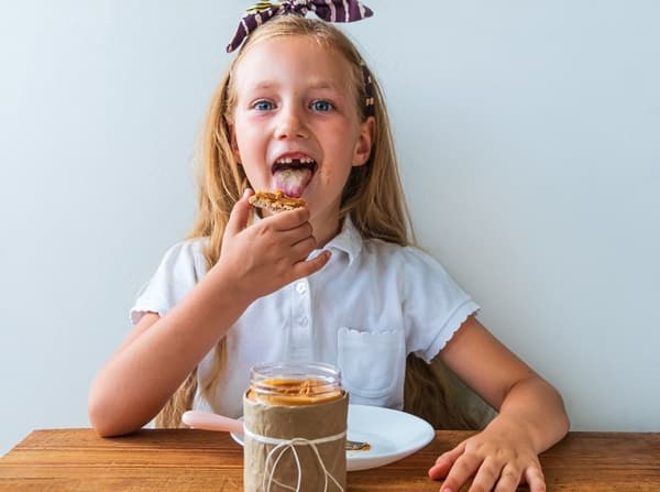 child eating peanut butter